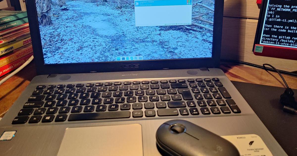 a bluetooth logitech mouse, sitting on the laptop